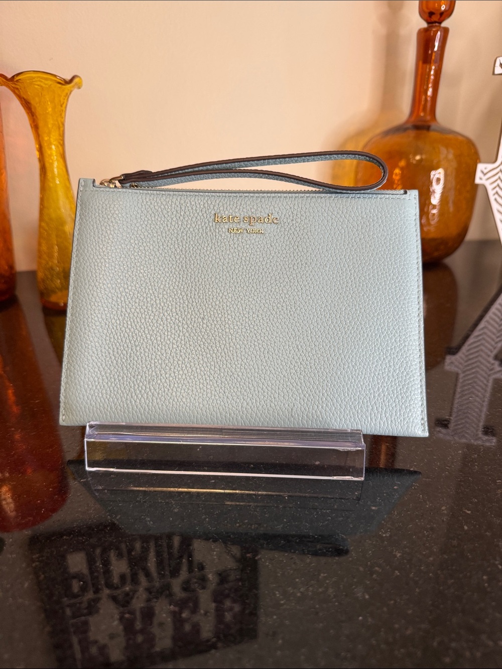 kate spade pale blue pebbled leather wristlet with gold logo